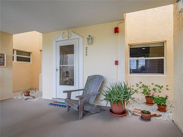 doorway to property with stucco siding