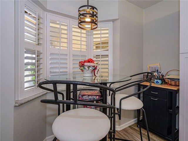 dining room featuring wood finished floors and baseboards