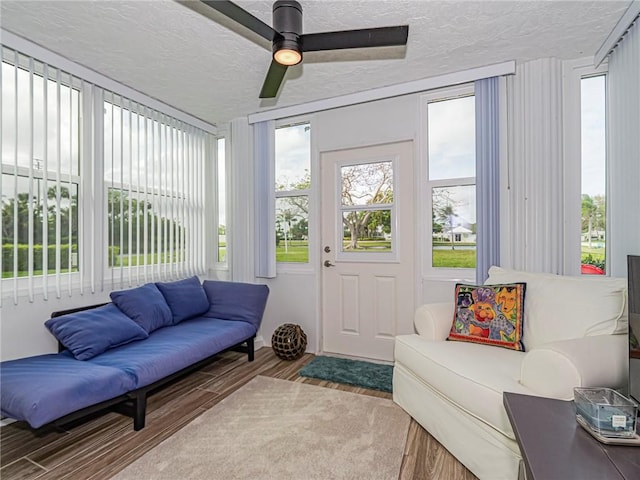 sunroom / solarium featuring ceiling fan