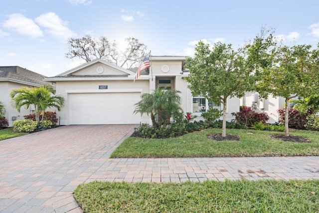 view of front of house with a front yard and a garage