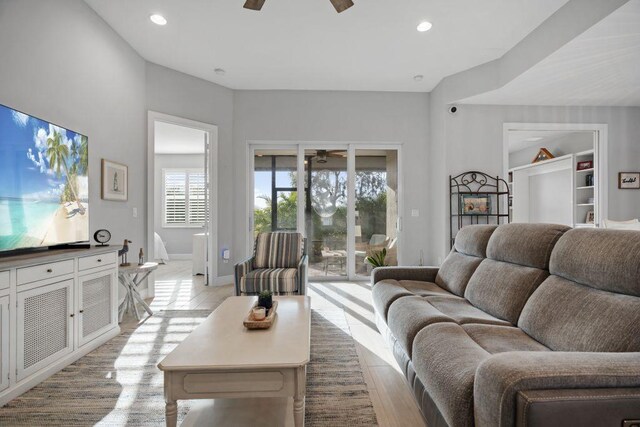 living room featuring ceiling fan and light hardwood / wood-style floors