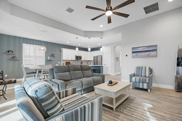 living room with ceiling fan and hardwood / wood-style flooring