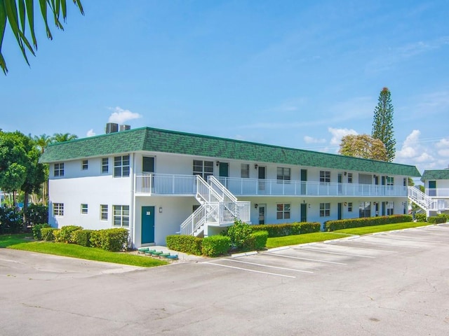 2800 Indian River Blvd Unit 2S, Vero Beach, FL 32960 - view of property with stairs and uncovered parking