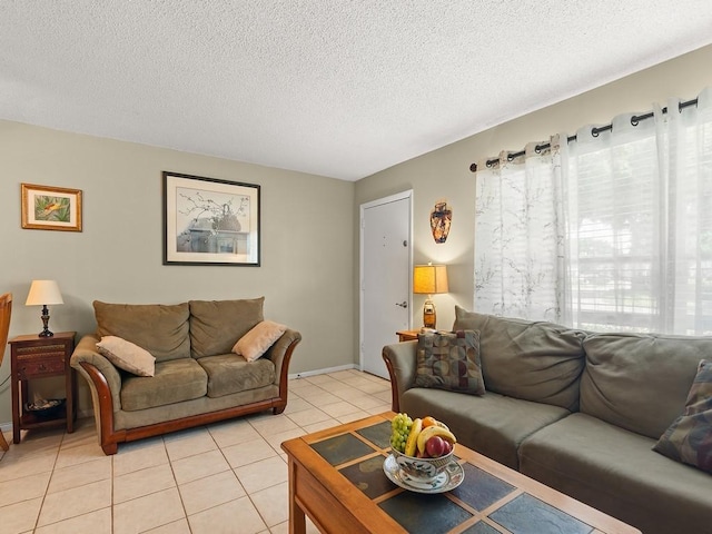 2800 Indian River Blvd Unit 2S, Vero Beach, FL 32960 - living room featuring light tile patterned flooring, a textured ceiling, and baseboards