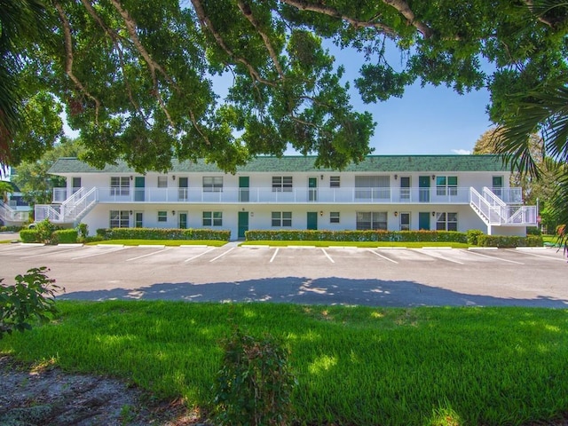 2800 Indian River Blvd Unit 2S, Vero Beach, FL 32960 - view of building exterior with uncovered parking and stairway