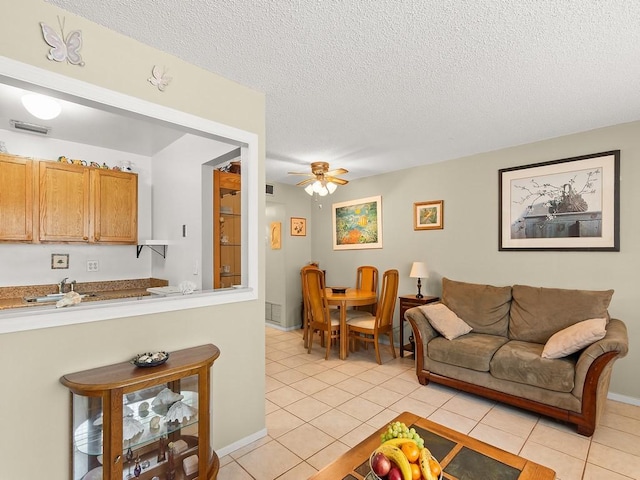 2800 Indian River Blvd Unit 2S, Vero Beach, FL 32960 - living room featuring light tile patterned flooring, a textured ceiling, and a ceiling fan
