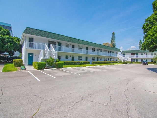 2800 Indian River Blvd Unit 2S, Vero Beach, FL 32960 - view of building exterior with uncovered parking and stairway