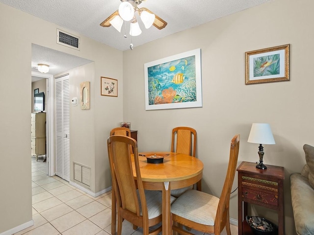 2800 Indian River Blvd Unit 2S, Vero Beach, FL 32960 - dining space featuring a ceiling fan, light tile patterned flooring, baseboards, and a textured ceiling
