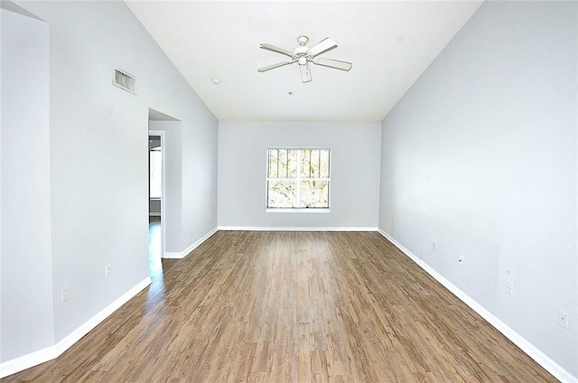 empty room featuring ceiling fan, wood-type flooring, and vaulted ceiling