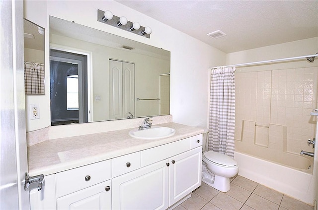 full bathroom with vanity, toilet, tile patterned floors, a textured ceiling, and shower / bath combo with shower curtain