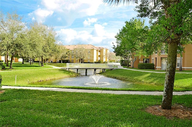 view of home's community featuring a water view and a yard