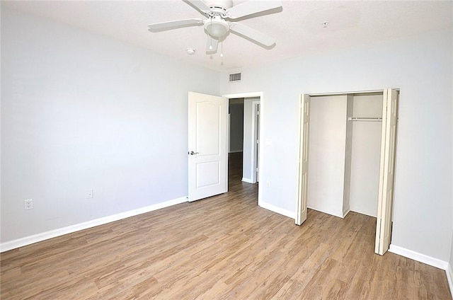 unfurnished bedroom with ceiling fan, a closet, and light wood-type flooring