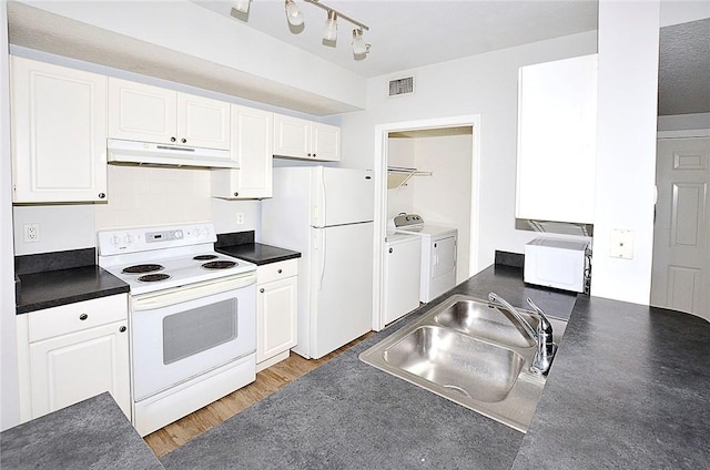 kitchen featuring sink, white appliances, wood-type flooring, white cabinets, and separate washer and dryer