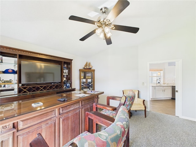 bar with carpet flooring, a ceiling fan, and a sink