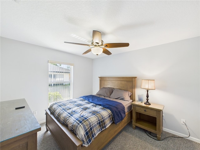 carpeted bedroom with baseboards and ceiling fan