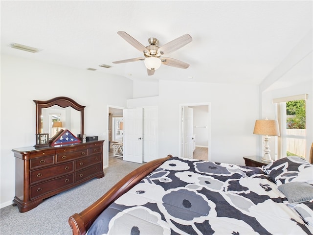 bedroom featuring light carpet, visible vents, and lofted ceiling