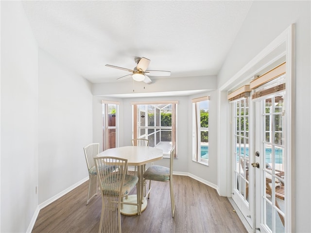 dining area featuring ceiling fan, french doors, baseboards, and wood finished floors