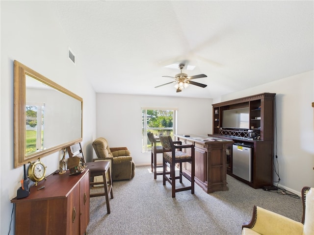 office with light carpet, visible vents, baseboards, and ceiling fan