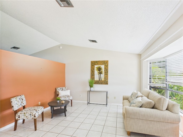108 Cardinal Dr, Sebastian, FL 32958 - living area with lofted ceiling, light tile patterned floors, and a textured ceiling