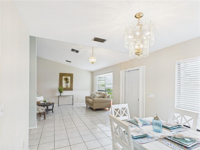 108 Cardinal Dr, Sebastian, FL 32958 - dining area with a chandelier, lofted ceiling, and light tile patterned flooring