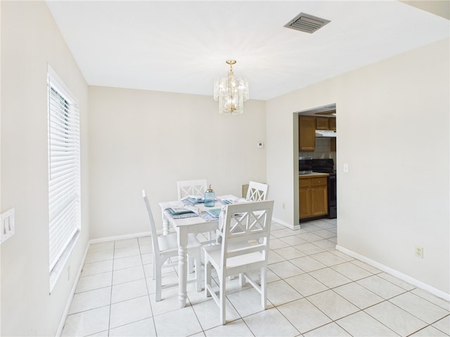 108 Cardinal Dr, Sebastian, FL 32958 - dining area with a chandelier and light tile patterned flooring