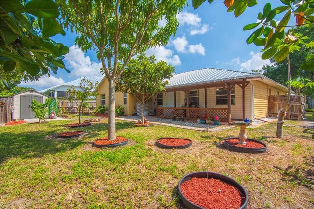 1359 Damask Ln, Sebastian, FL 32958 - single story home with a storage unit, an outdoor structure, and metal roof