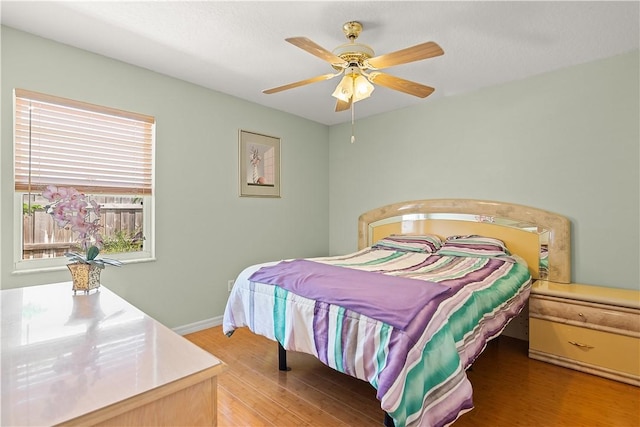 1359 Damask Ln, Sebastian, FL 32958 - bedroom featuring wood finished floors, a ceiling fan, and baseboards