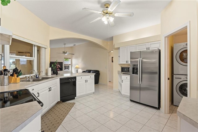 1359 Damask Ln, Sebastian, FL 32958 - kitchen with black appliances, ceiling fan, stacked washer and clothes dryer, a sink, and white cabinets