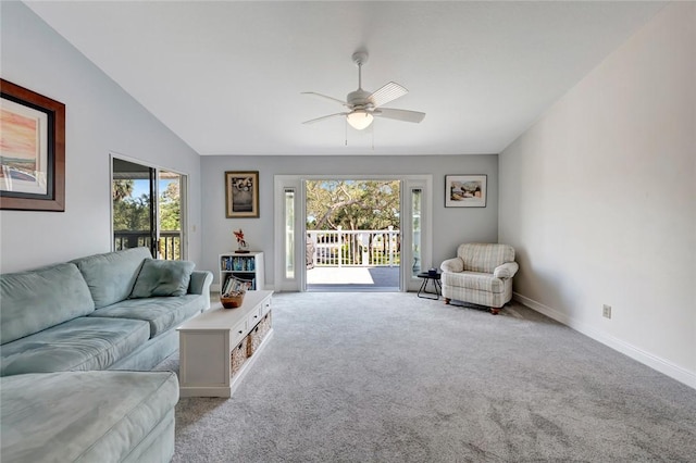 living room featuring vaulted ceiling, a wealth of natural light, light colored carpet, and ceiling fan