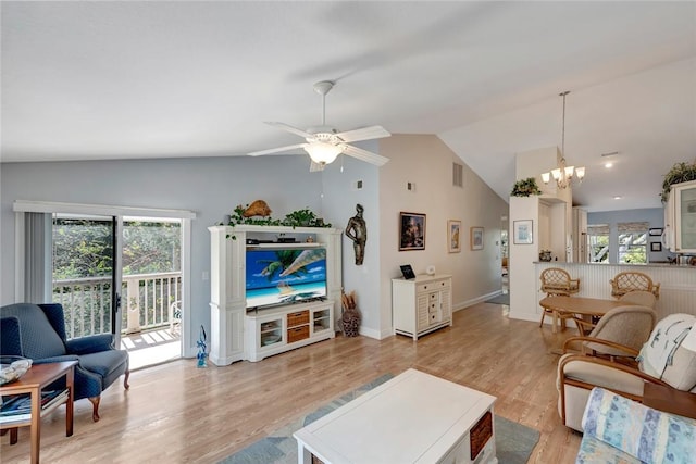 living room featuring lofted ceiling, ceiling fan with notable chandelier, and light wood-type flooring