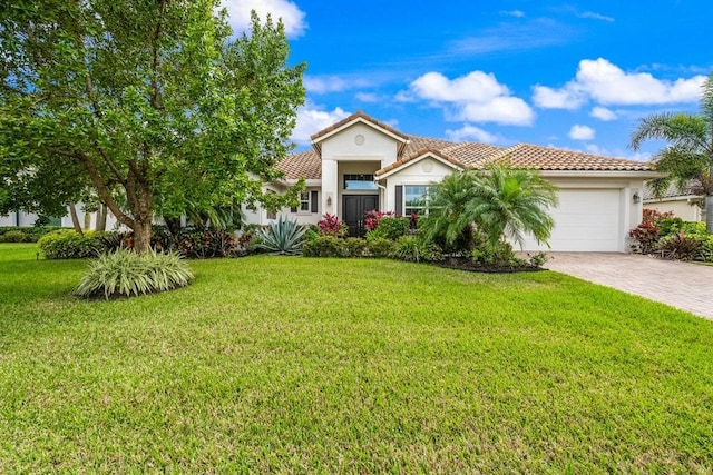 mediterranean / spanish-style house featuring a tile roof, a front yard, stucco siding, decorative driveway, and a garage