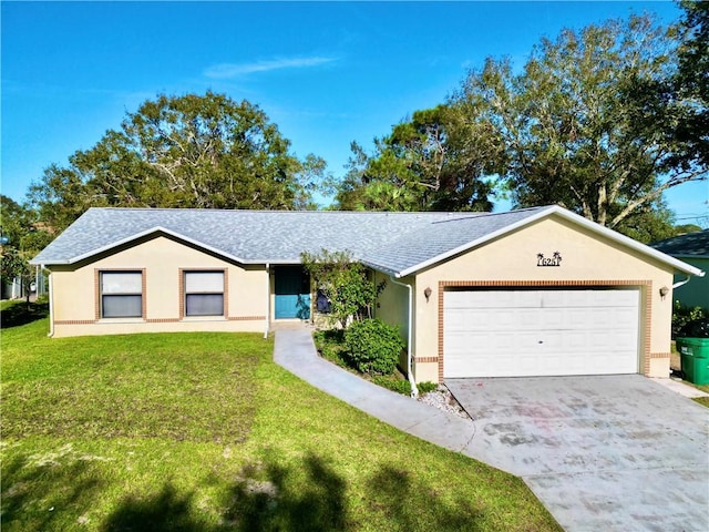 single story home with a garage and a front lawn