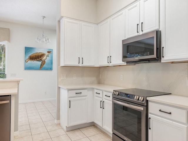 kitchen featuring hanging light fixtures, stainless steel appliances, light tile patterned floors, a chandelier, and white cabinets