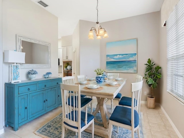 dining area with light tile patterned flooring, visible vents, an inviting chandelier, and baseboards