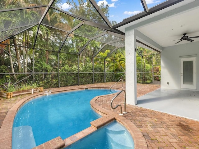 pool with a lanai, a patio area, and ceiling fan