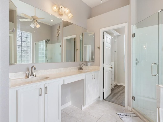 bathroom featuring tile patterned flooring, vanity, ceiling fan, and an enclosed shower