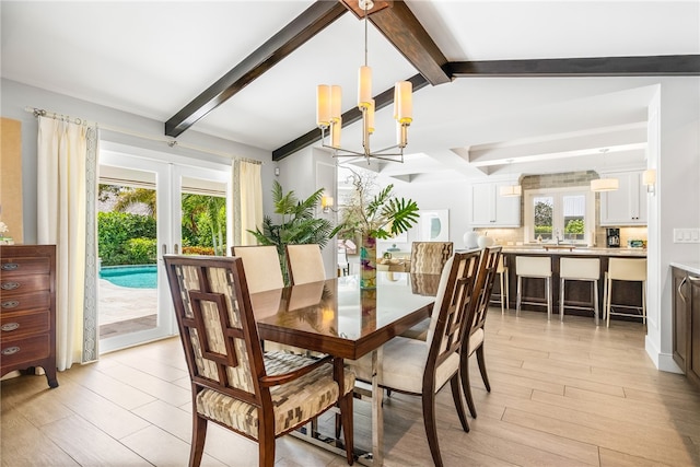 dining room featuring beam ceiling, french doors, light wood-type flooring, and an inviting chandelier