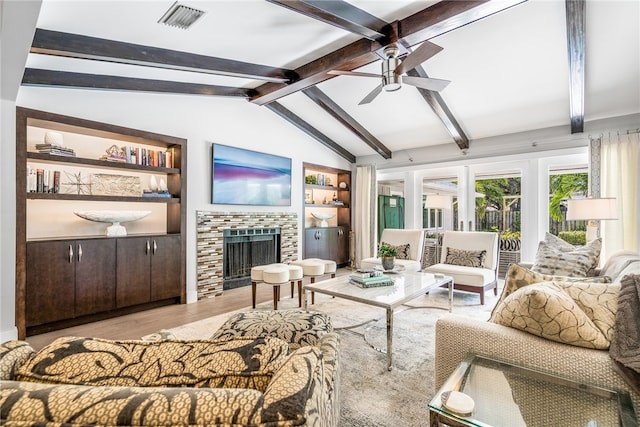 living room featuring ceiling fan, lofted ceiling with beams, light hardwood / wood-style flooring, built in features, and a fireplace