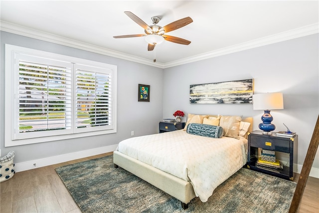 bedroom with ceiling fan, wood-type flooring, and crown molding