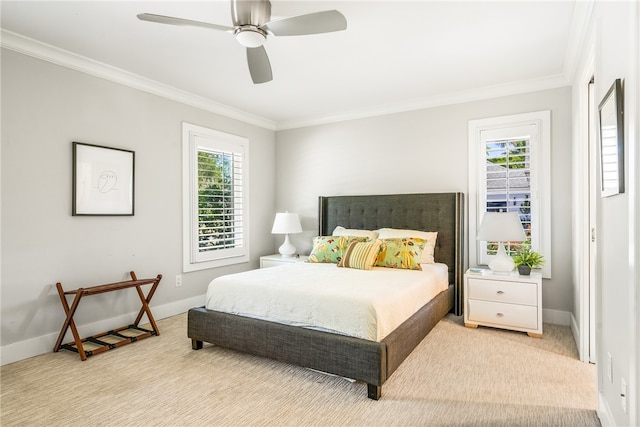 carpeted bedroom featuring ceiling fan and crown molding