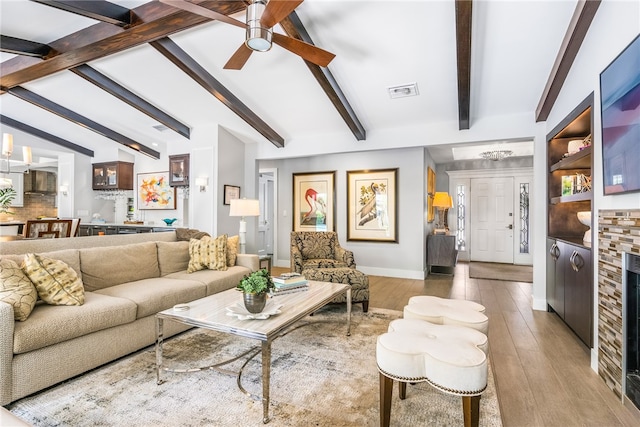 living room featuring lofted ceiling with beams, hardwood / wood-style flooring, and ceiling fan