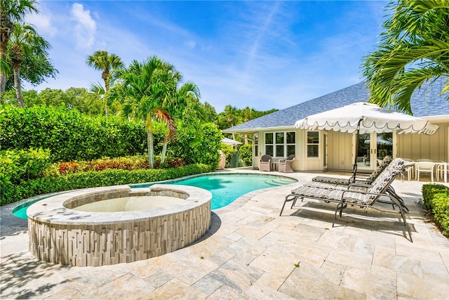 view of pool with a patio area, an in ground hot tub, and french doors