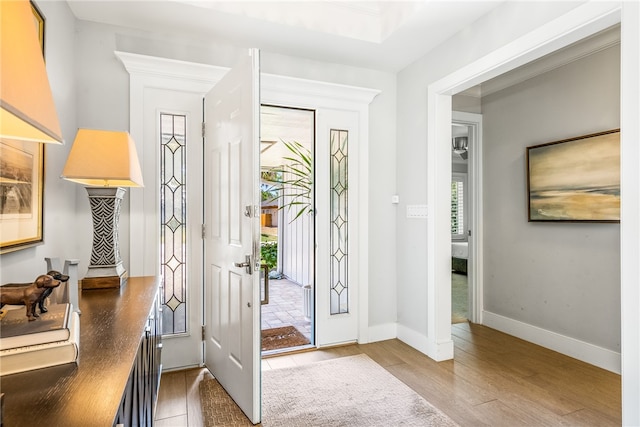 foyer featuring hardwood / wood-style flooring and crown molding