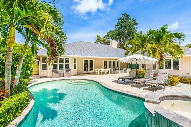 view of pool featuring a patio and french doors