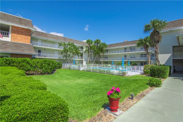 view of community with a lawn and a pool