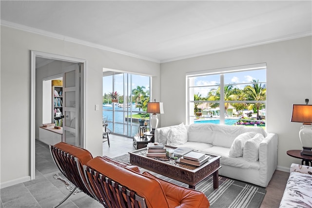 living room with a water view and crown molding