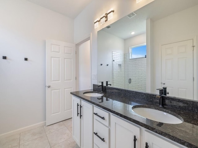 full bathroom featuring tile patterned floors, a sink, double vanity, and a shower stall