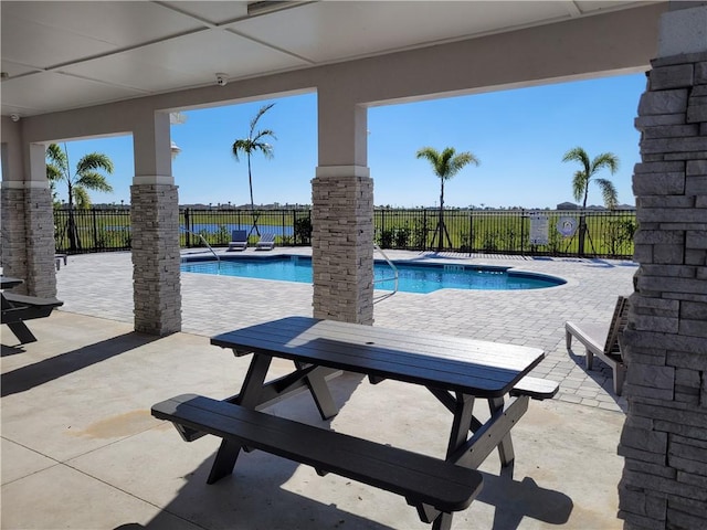 pool featuring a fenced backyard and a patio