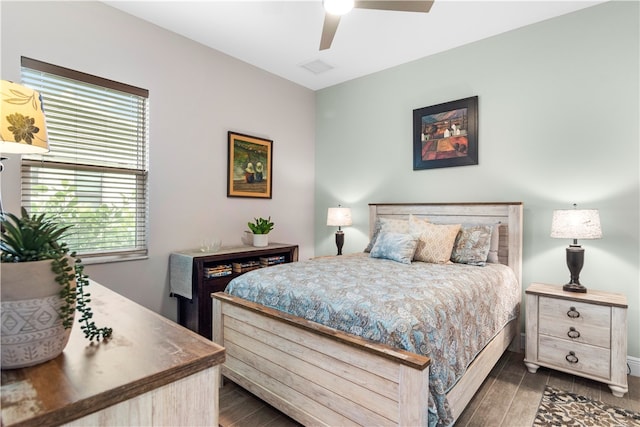 bedroom with dark hardwood / wood-style flooring and ceiling fan