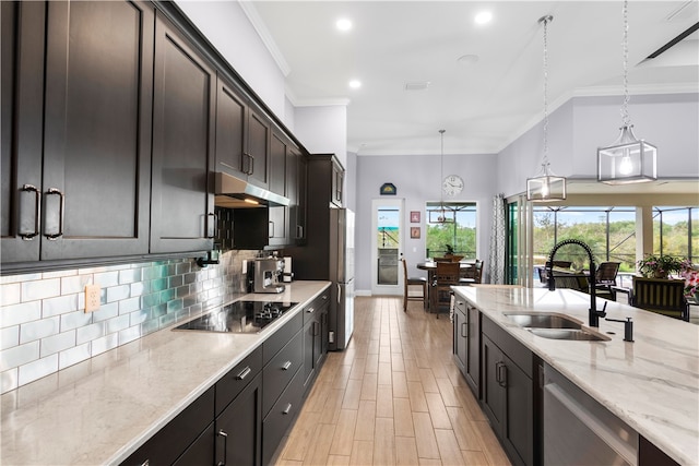 kitchen featuring stainless steel appliances, hanging light fixtures, sink, ornamental molding, and light stone countertops